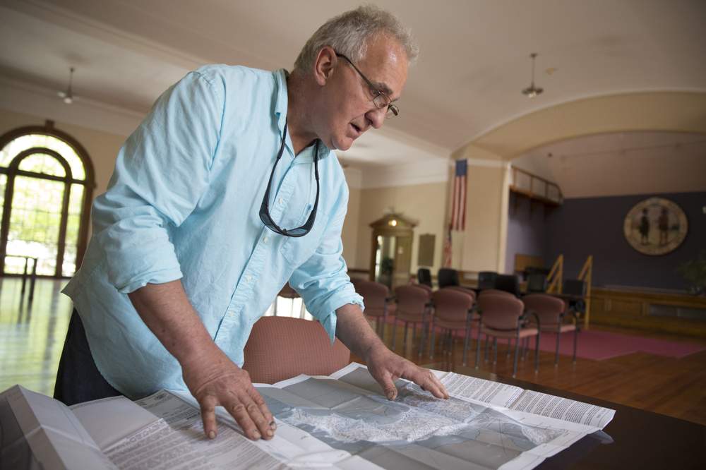 Enzo Barile looks over federal flood-risk maps for Nahant.